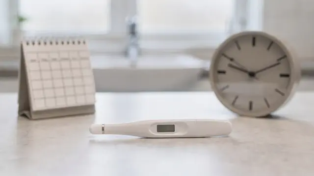 Schwangerschaftstest und Kalender bei verspäteter Periode in einem Badezimmer